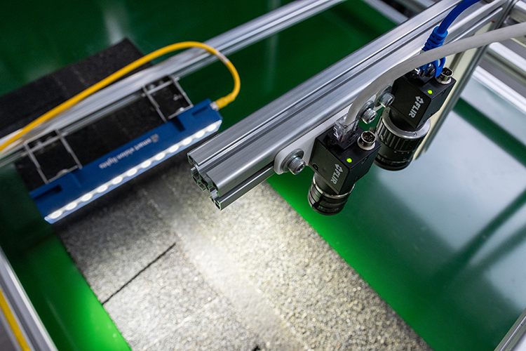 Zetamotion inspection lab setup analyzing a roofing shingle sample with dual cameras and lighting.