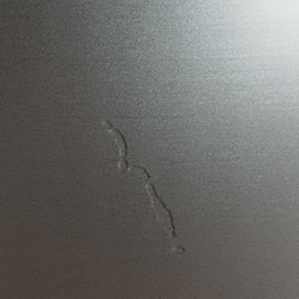 Metallic surface sample with synthetic crack defect for AI-powered quality inspection dataset.