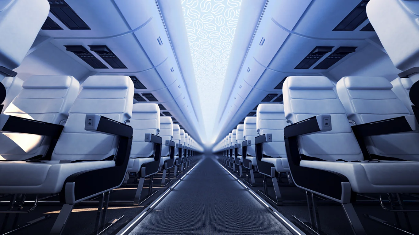 Aircraft cabin interior featuring Aviation Glass LED-backlit ceiling panels with airplane-silhouette pattern—products inspected by Spectron™ AI for micro-defects